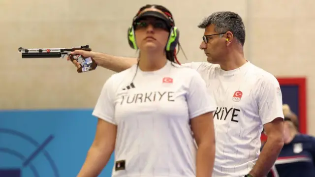 Silver medallists Sevval Ilayda Tarhan of Turkey and Yusuf Dikec (R) of Turkey shooting in Paris.