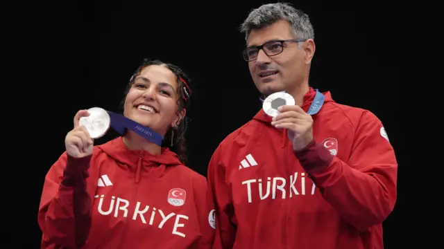 Silver medallists Sevval Ilayda Tarhan of Turkey and Yusuf Dikec (R) of Turkey pose with their medals.